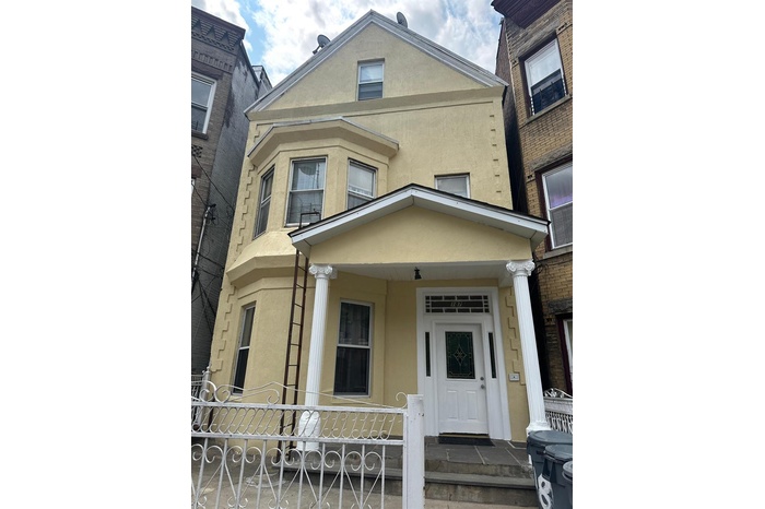 View of front of home featuring stucco siding and a porch