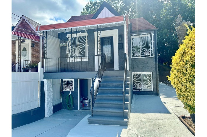 View of front of home featuring board and batten siding and roof with shingles
