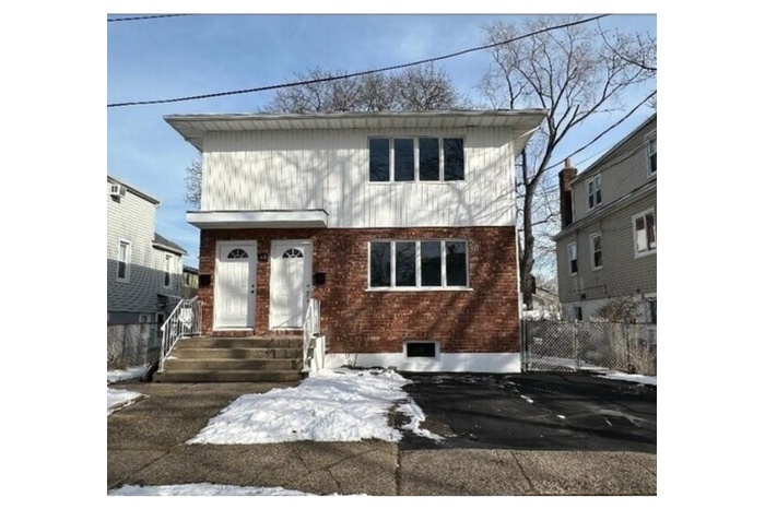View of front of home featuring entry steps and brick siding