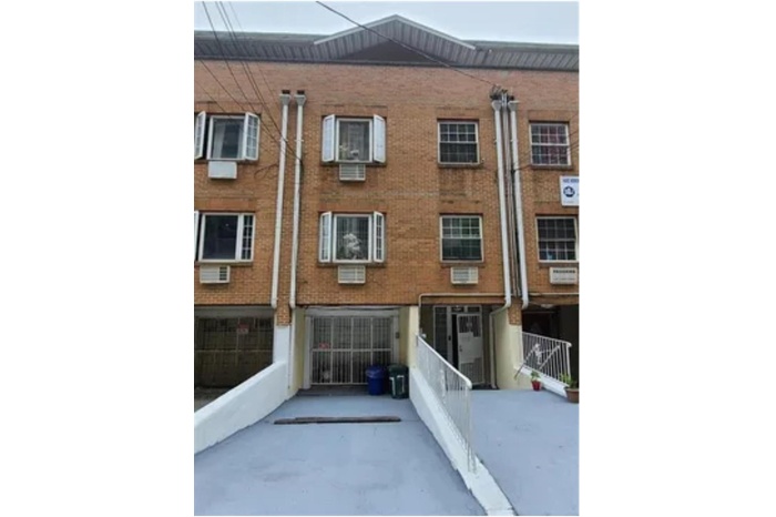 Back of house featuring brick siding