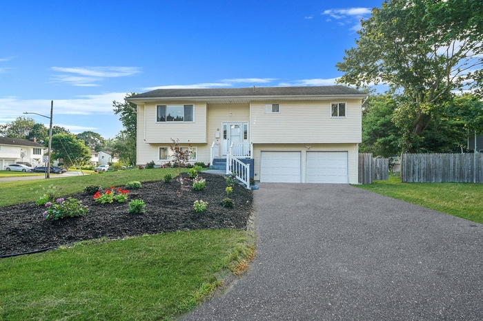 HI ranch with an attached garage and driveway