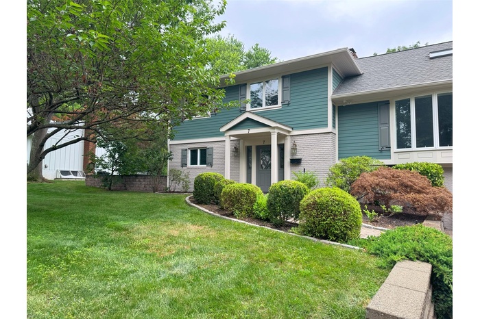 View of front of home with a front lawn and brick siding