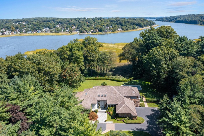 Bird's eye view of a nearby body of water and a forest