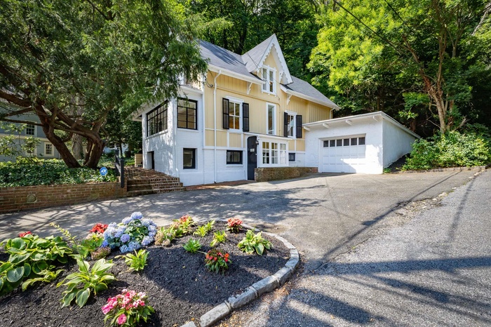 view of side of house with garage, and driveway
