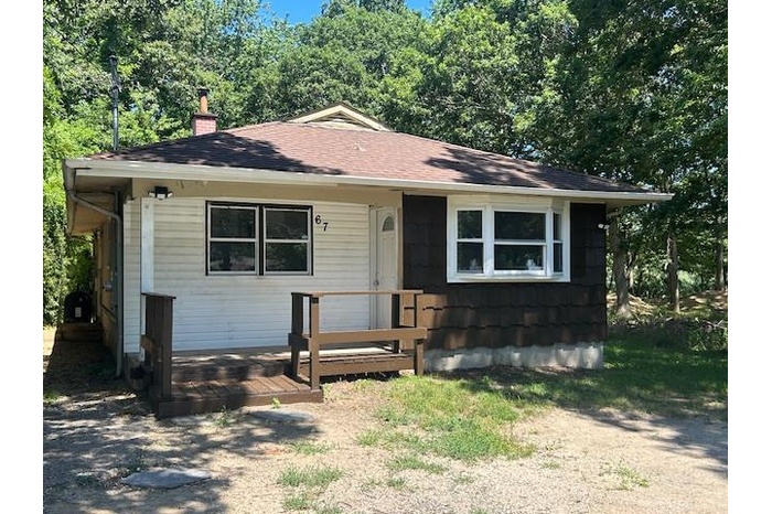 Bungalow featuring a chimney and roof with shingles