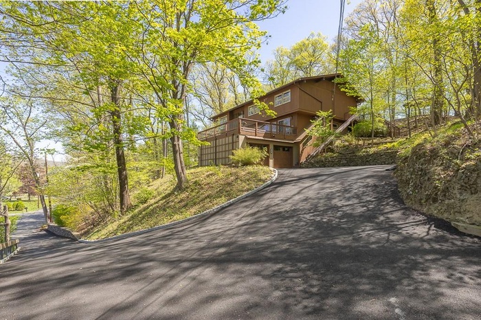 View of front of property featuring a garage and driveway