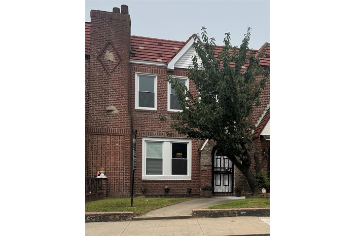 View of front of house featuring brick siding