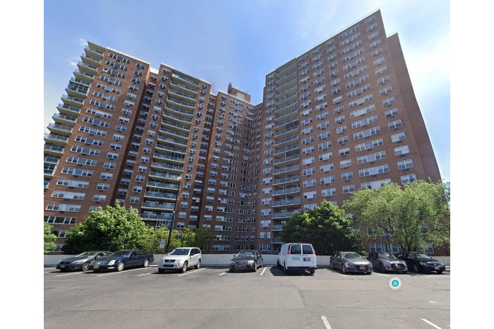 View of property with uncovered parking