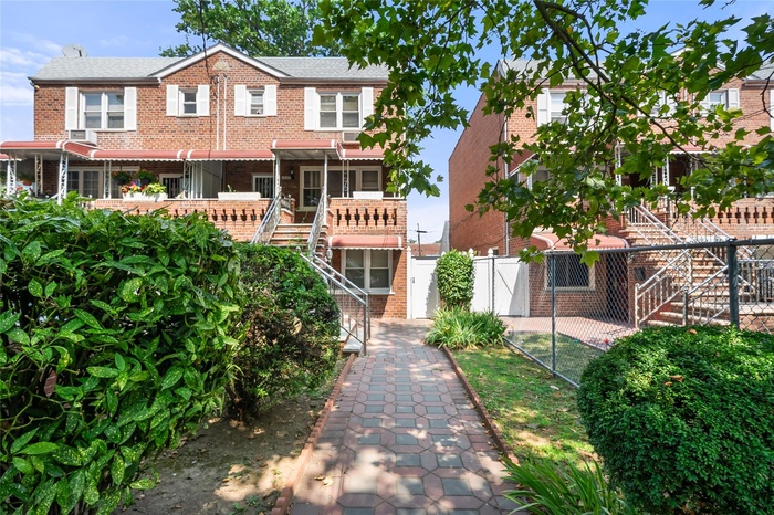 View of front of house with brick siding and stairs