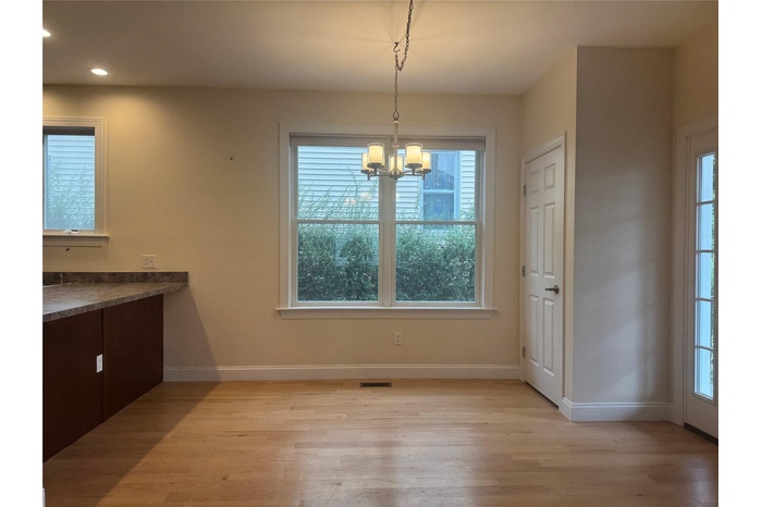 Unfurnished dining area featuring light wood-type flooring, a chandelier, and recessed lighting