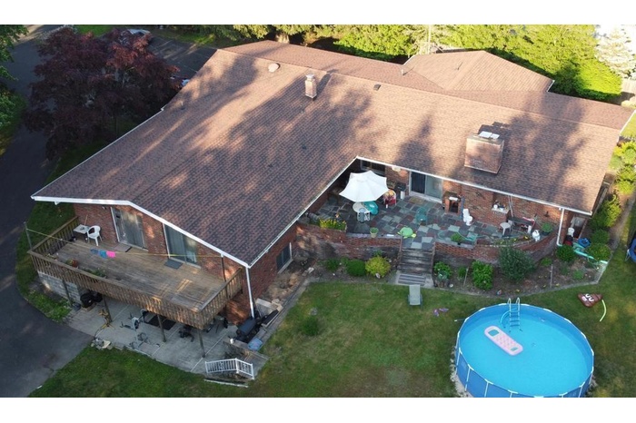 Aerial view of property and surrounding area featuring property parcel outlined