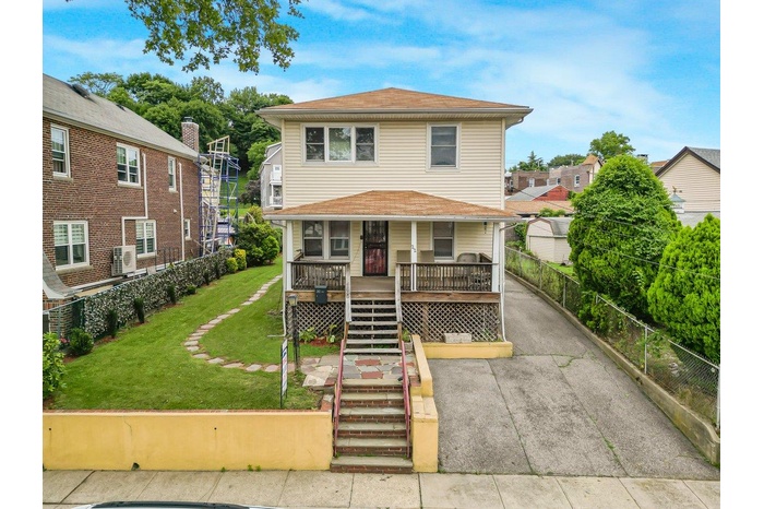 American foursquare style home with covered porch and stairs
