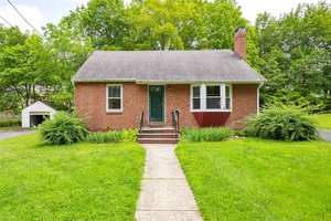 Welcome to this beautifully maintained brick faced Cape Cod in the heart of the Village of New Paltz.