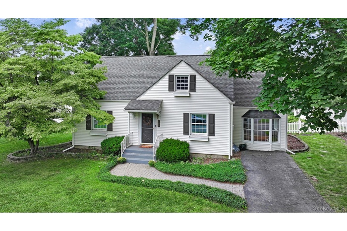 View of front of property with roof with shingles
