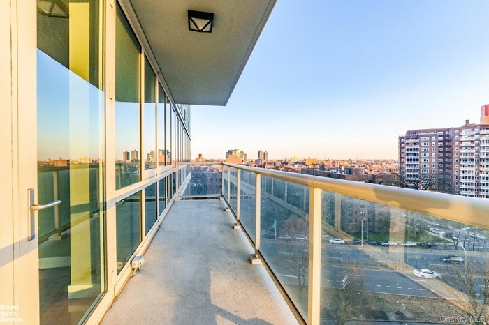 Balcony at dusk featuring a city view