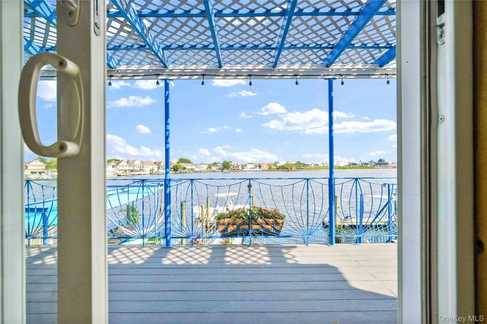Wooden terrace featuring a water view