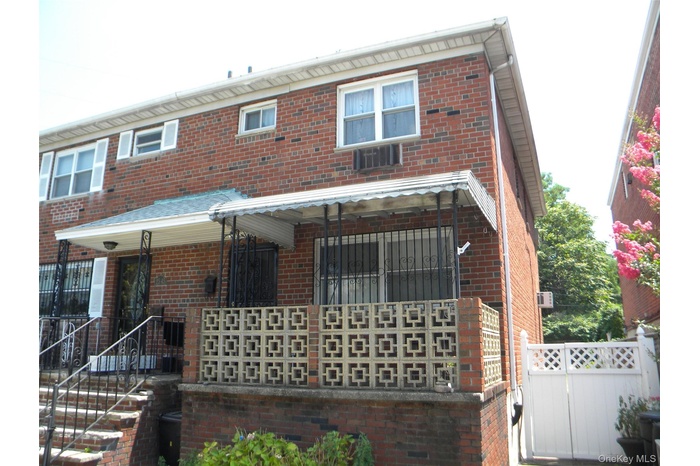 Rear view of property with brick siding
