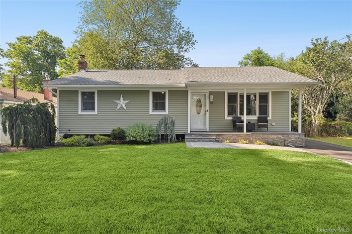 View of front of home featuring a front yard and porch