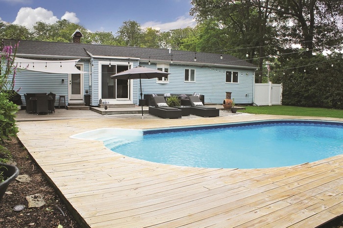 Rear view of property with an outdoor hangout area, a deck, entry steps, and a chimney