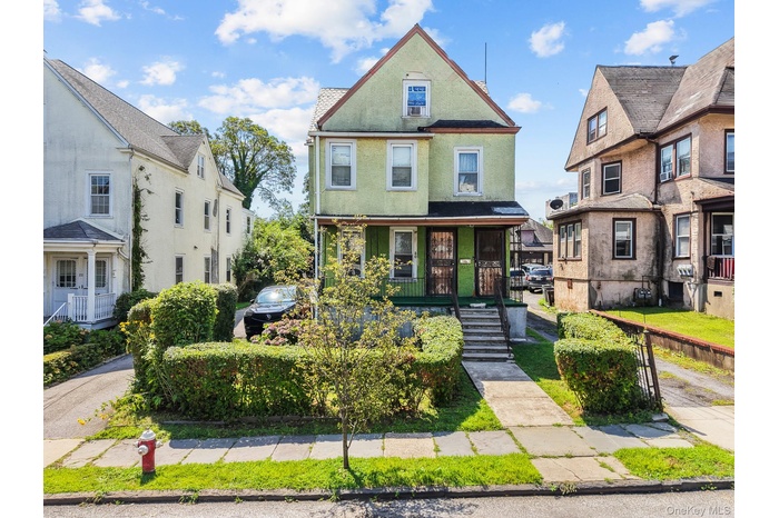 Victorian home featuring a porch and stucco siding