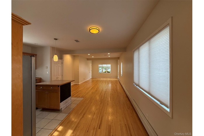Hall featuring light wood-type flooring and recessed lighting