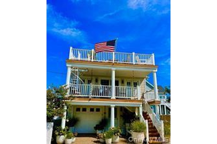 View of front facade with a balcony and an attached garage