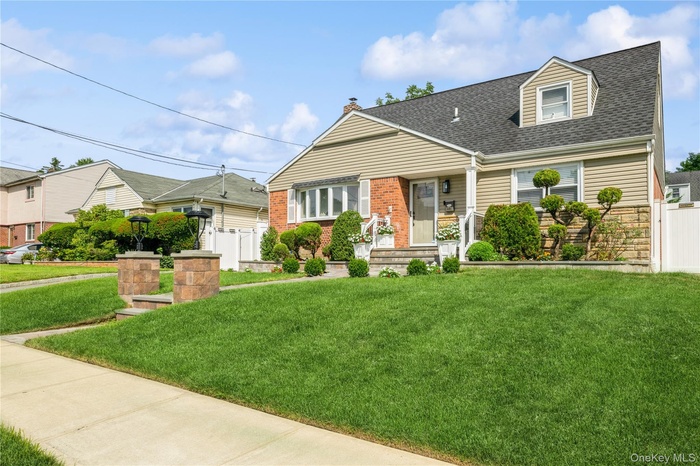 View of front of home with roof with shingles