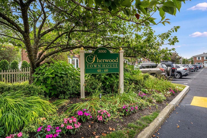 Community / neighborhood sign with uncovered parking