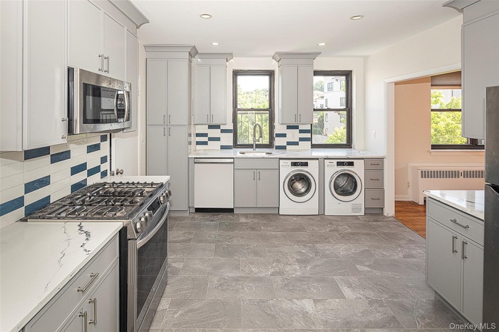 This new kitchen with in unit laundry greets you as you enter your new home