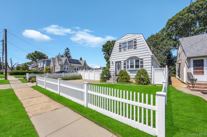 View of front facade with a fenced front yard and a residential view