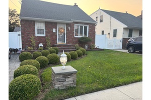 This beautiful five bedroom, two bathroom, dormered brick Cape Cod features a cozy living room with a fireplace, a dining room, and a spacious eat in kitchen with granite countertops.