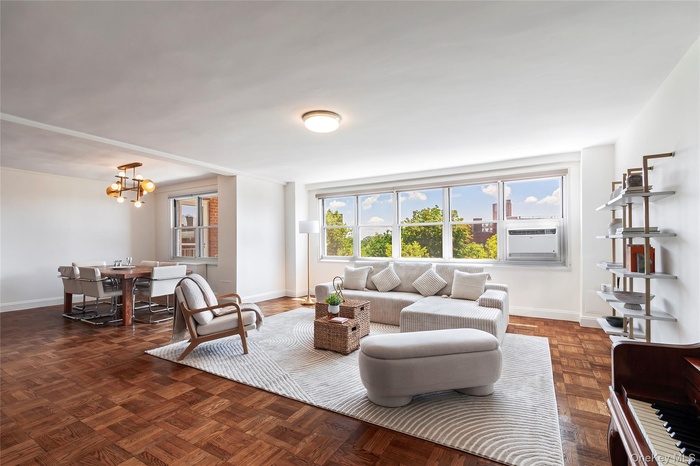 Living area featuring a chandelier and baseboards