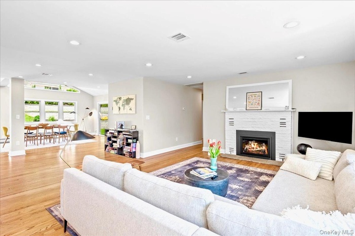 Living room with  lofted ceiling, and recessed lighting