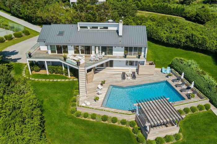 Rear view of house featuring a metal roof, a standing seam roof, a patio, and a yard