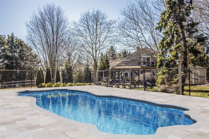 View of swimming pool with a fenced in pool, a patio, and fence