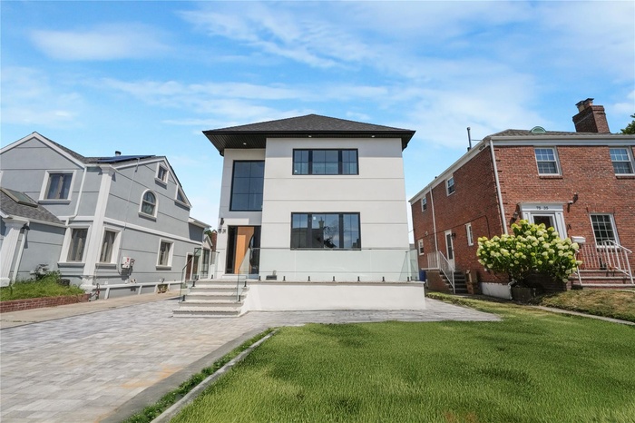 Rear view of house featuring a lawn