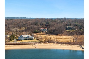 Welcome to 15 Hoffstot Lane, a stunning stucco and terracotta roofed Colonial home, offering panoramic views of the water and marshlands.