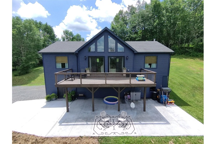 Rear view of property with a patio area, a lawn, and a deck
