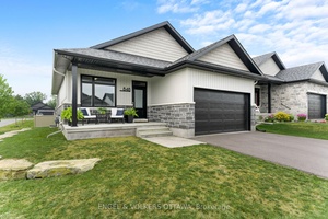 Welcome to 848 Reaume Street, a beautifully upgraded Neilcorp bungalow located on a large corner lot in Almonte.