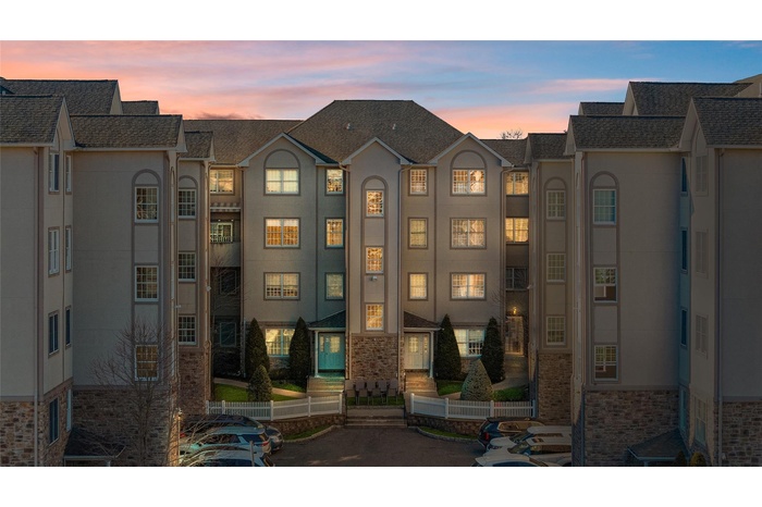 View of property at dusk