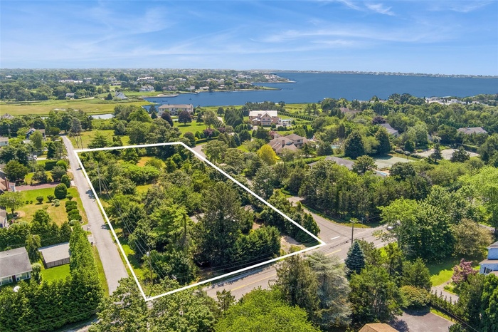 Aerial view of property's location featuring a large body of water and property boundaries highlighted