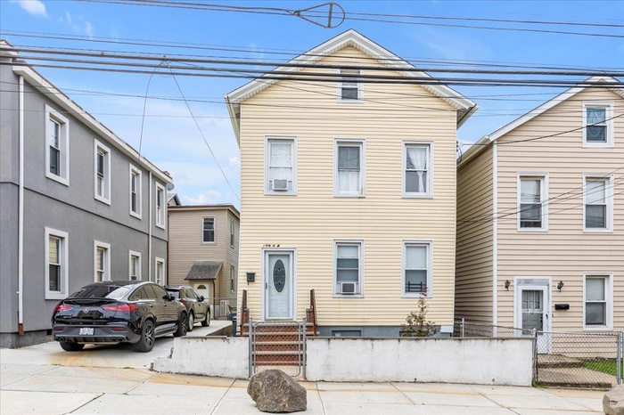 View of front of property featuring a fenced front yard and a residential view