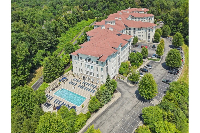 Bird's eye view of a pool area and a forest