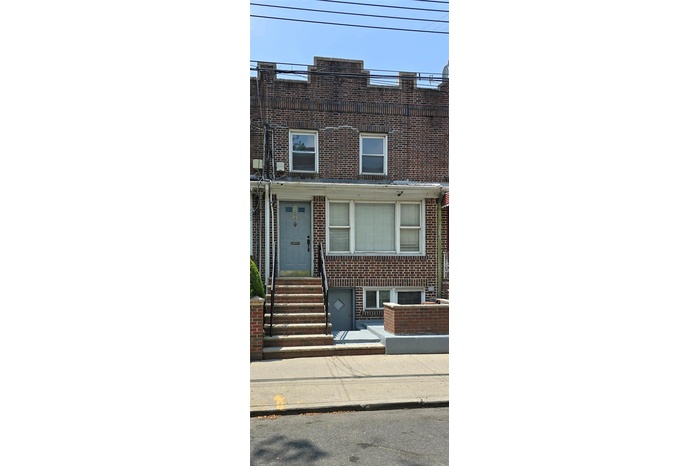 View of property featuring brick siding