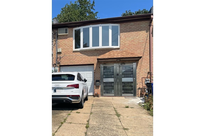 View of front of property with brick siding and driveway