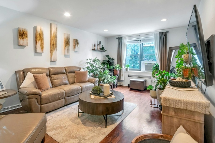 Living room featuring wood finished floors, cooling unit, and recessed lighting