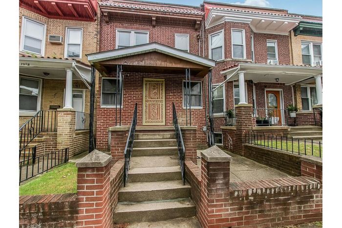 View of front of house with brick siding and entry steps