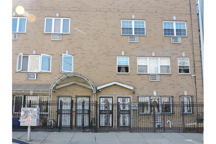 View of property featuring a fenced front yard