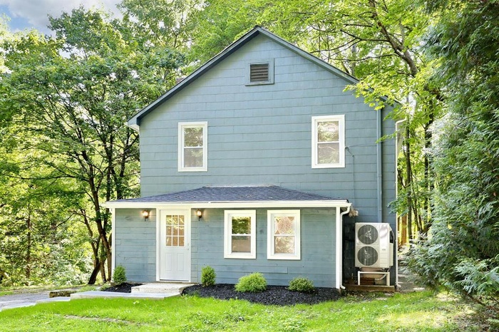 Back of property featuring a lawn