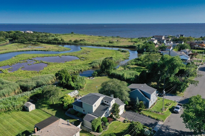 View of property location with a large body of water and nearby suburban area